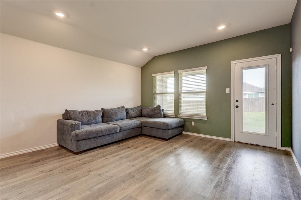 1016 Rio Bravo Drive Forney, TX 75126 - Photo 10 of 25 Spacious living area featuring wood-finish flooring, recessed lighting, and a vaulted ceiling