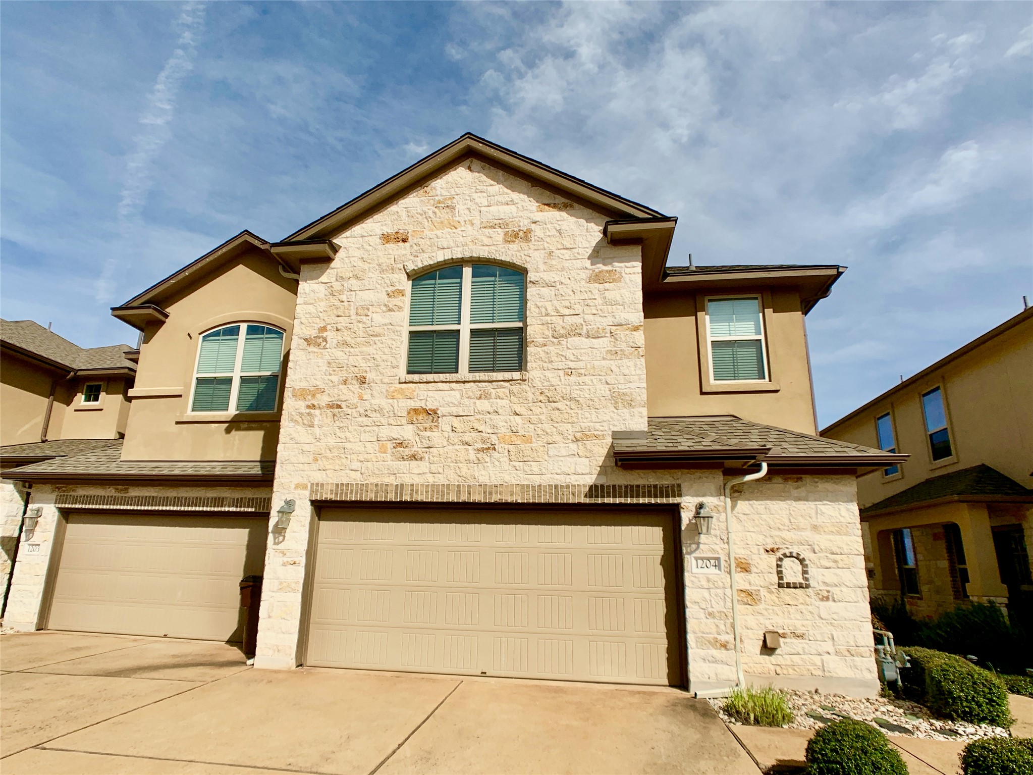 14001 Avery Ranch Boulevard, Unit 1204 Austin, TX 78717 - Photo 15 of 18 a front view of a house with a garage