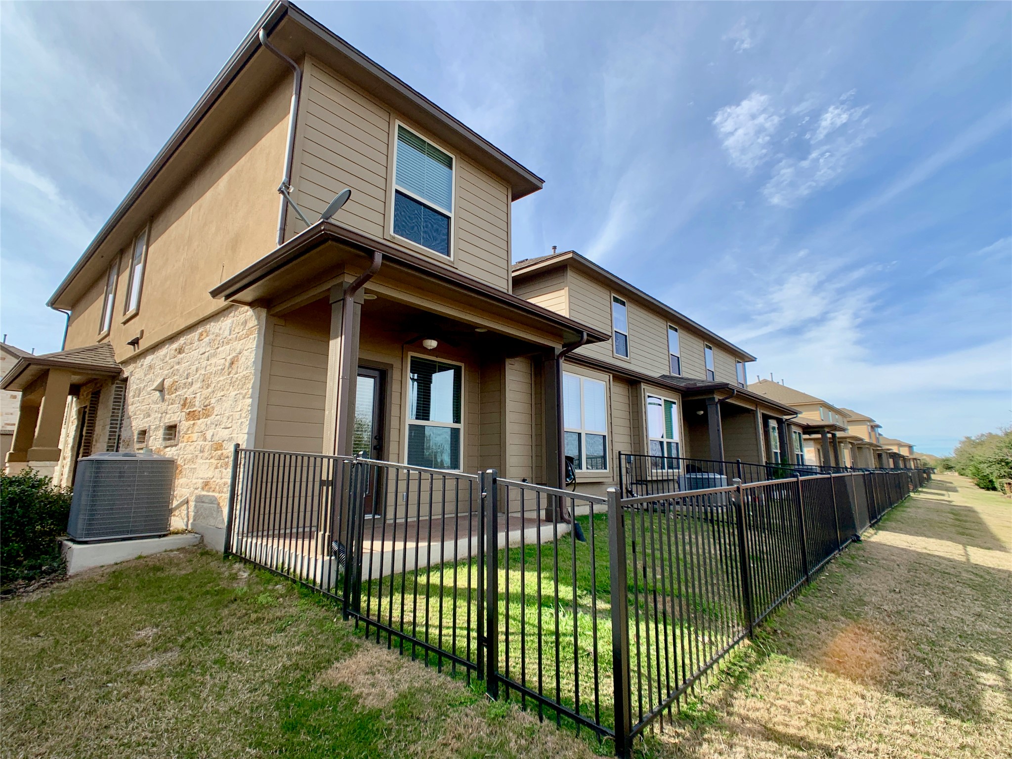 14001 Avery Ranch Boulevard, Unit 1204 Austin, TX 78717 - Photo 2 of 18 a view of house with a yard and floor to ceiling window