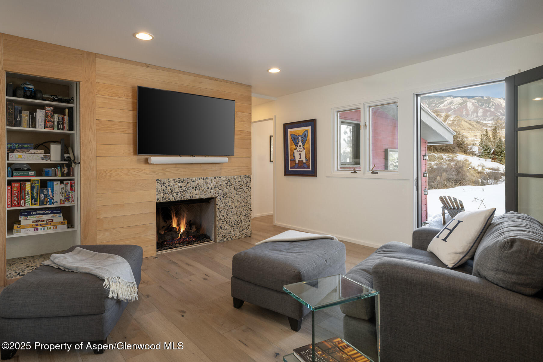 287 Meadow Road Snowmass Village, CO 81615 - Photo 18 of 20 a living room with furniture a flat screen tv and a fireplace