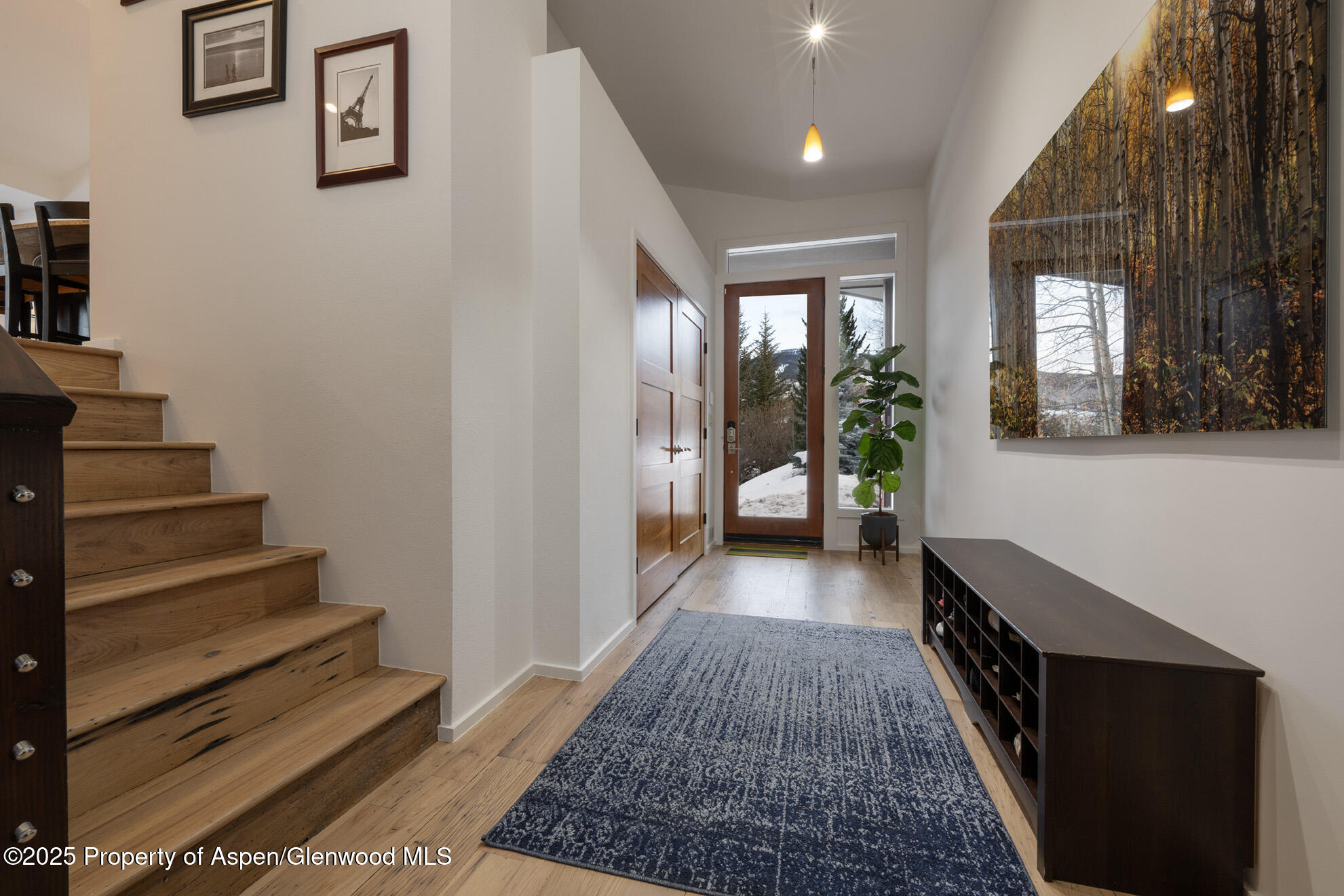 287 Meadow Road Snowmass Village, CO 81615 - Photo 20 of 20 a view of a hallway with wooden floor and staircase