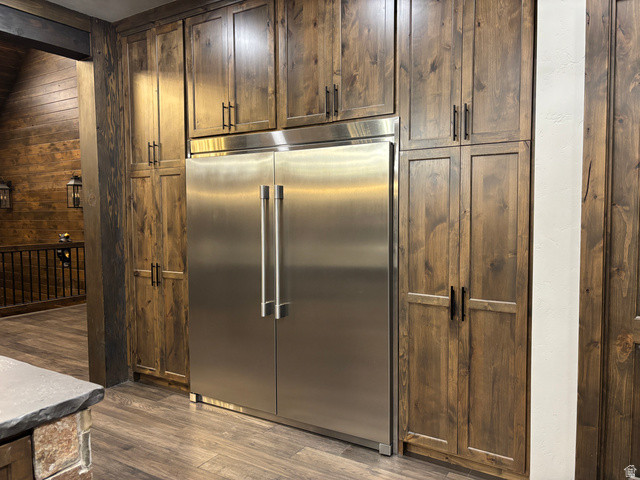 259 Meadow Drive Springville, UT 84663 - Photo 14 of 62 Kitchen with built in refrigerator, wooden walls, dark wood-type flooring, dark wood finish cabinetry, and beamed ceiling