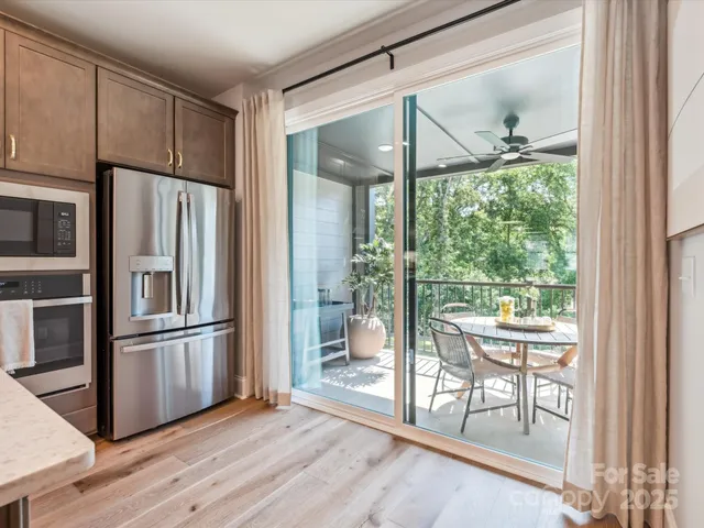 a kitchen with stainless steel appliances granite countertop a refrigerator and wooden floor