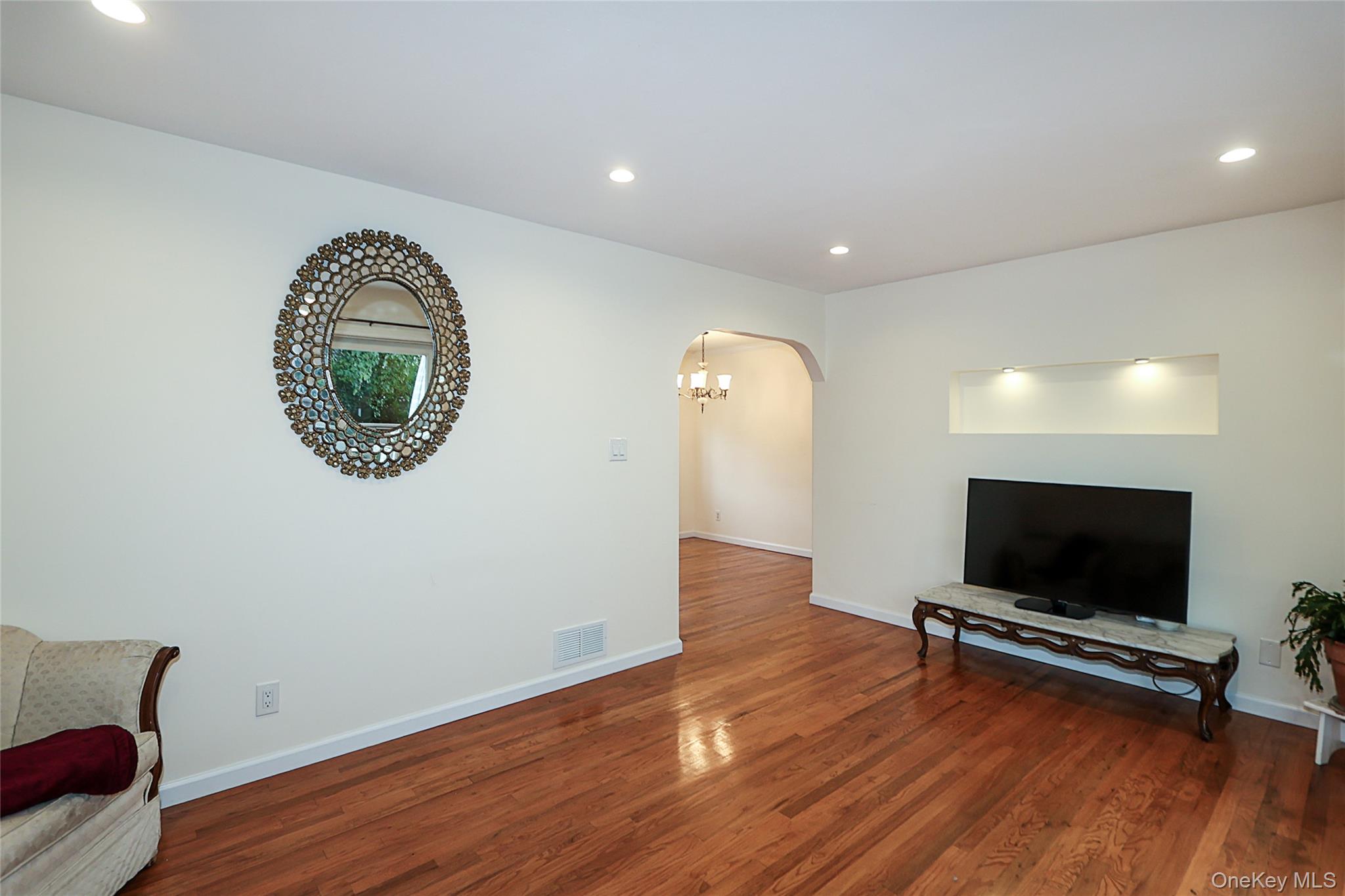 6 Gerhard Road Plainview, NY 11803 - Photo 12 of 29 a living room with furniture and a flat screen tv