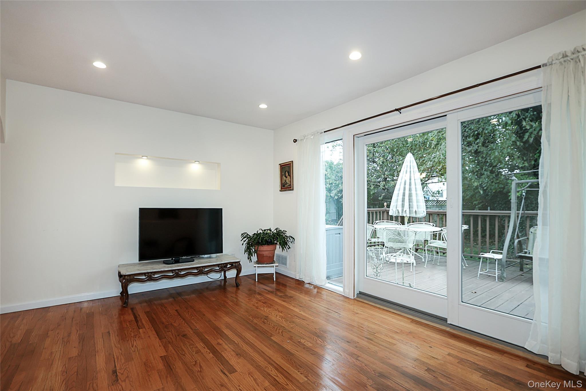 6 Gerhard Road Plainview, NY 11803 - Photo 13 of 29 a living room with furniture and a flat screen tv