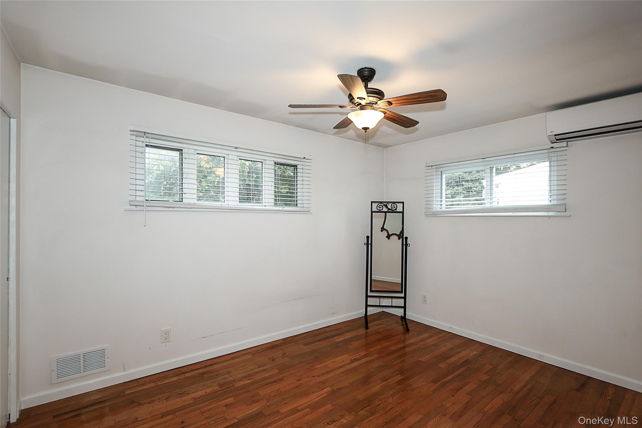 6 Gerhard Road Plainview, NY 11803 - Photo 15 of 29 a view of empty room with wooden floor and fan