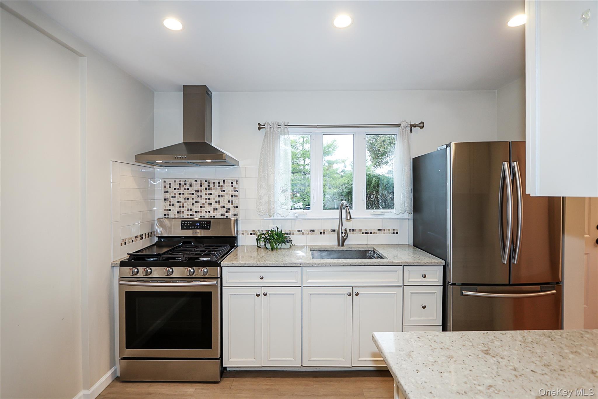 6 Gerhard Road Plainview, NY 11803 - Photo 2 of 29 a kitchen with stainless steel appliances a sink stove and refrigerator