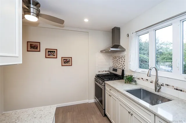 a kitchen with a stove a sink and a refrigerator