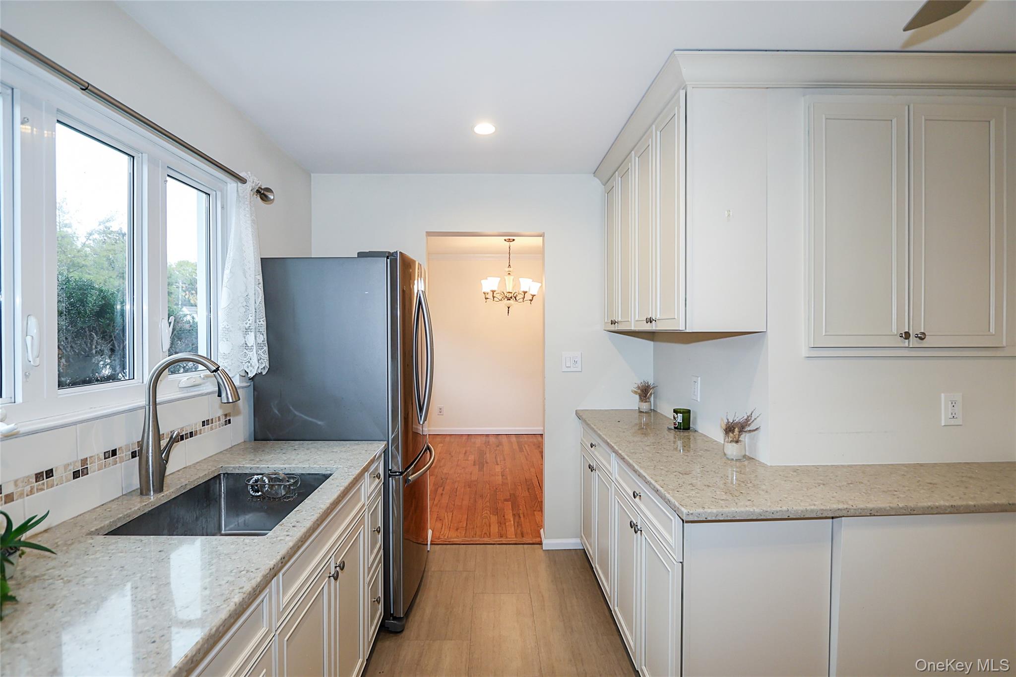 6 Gerhard Road Plainview, NY 11803 - Photo 4 of 29 a kitchen with stainless steel appliances granite countertop a sink stove and refrigerator