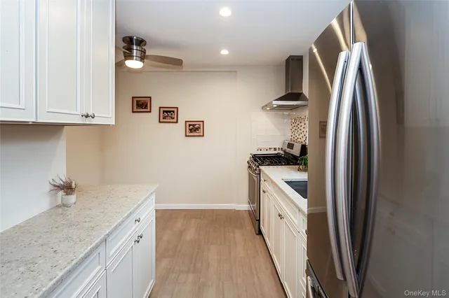 a kitchen with a sink a refrigerator and cabinets