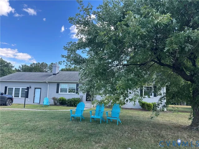 a view of a house with backyard porch and sitting area