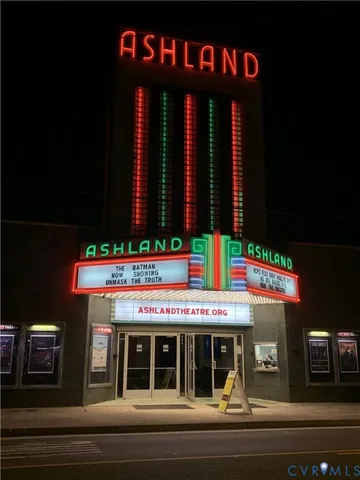 a front view of multi story residential apartment building with a yard