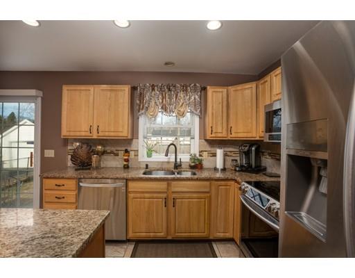 115 Eddy Street Springfield, MA 01104 - Photo 11 of 28 a kitchen with kitchen island granite countertop a sink window and cabinets