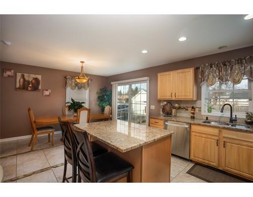 115 Eddy Street Springfield, MA 01104 - Photo 12 of 28 a kitchen with a dining table chairs and white appliances