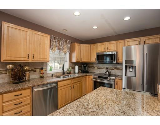 115 Eddy Street Springfield, MA 01104 - Photo 9 of 28 a kitchen with stainless steel appliances granite countertop a refrigerator a sink dishwasher a stove with wooden cabinets and a granite counter top