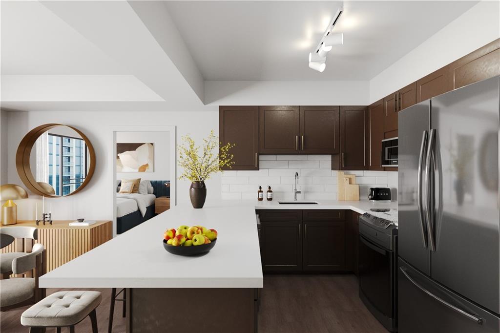 2460 Peachtree Road Northwest, Unit 304 Atlanta, GA 30305 - Photo 3 of 15 a kitchen with stainless steel appliances a table chairs and a refrigerator