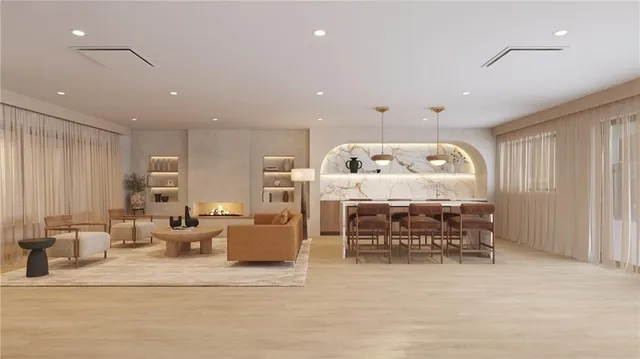 a living room with furniture and kitchen view