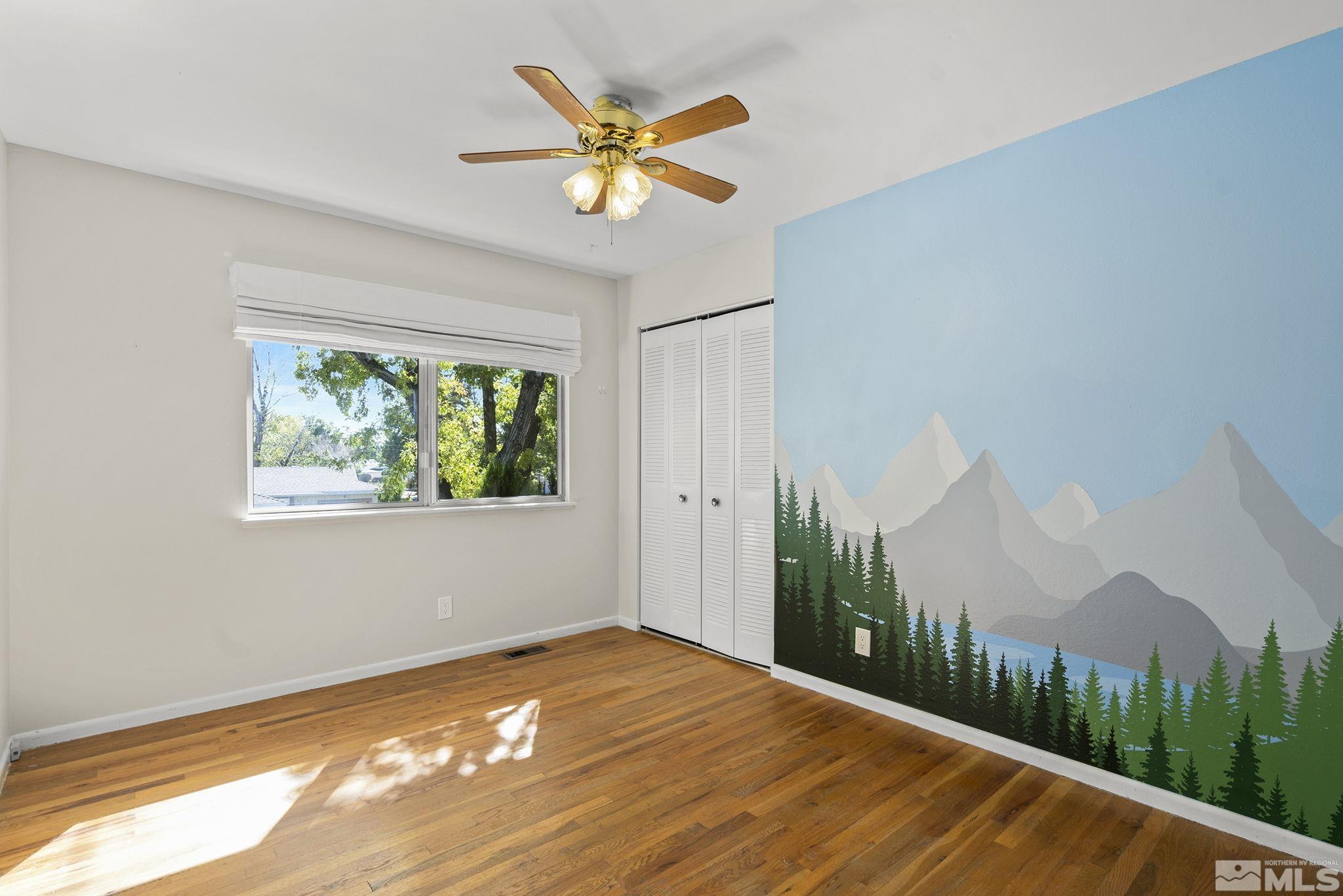 3495 Rauscher Drive Reno, NV 89503 - Photo 14 of 25 a view of a bedroom with wooden floor and a window