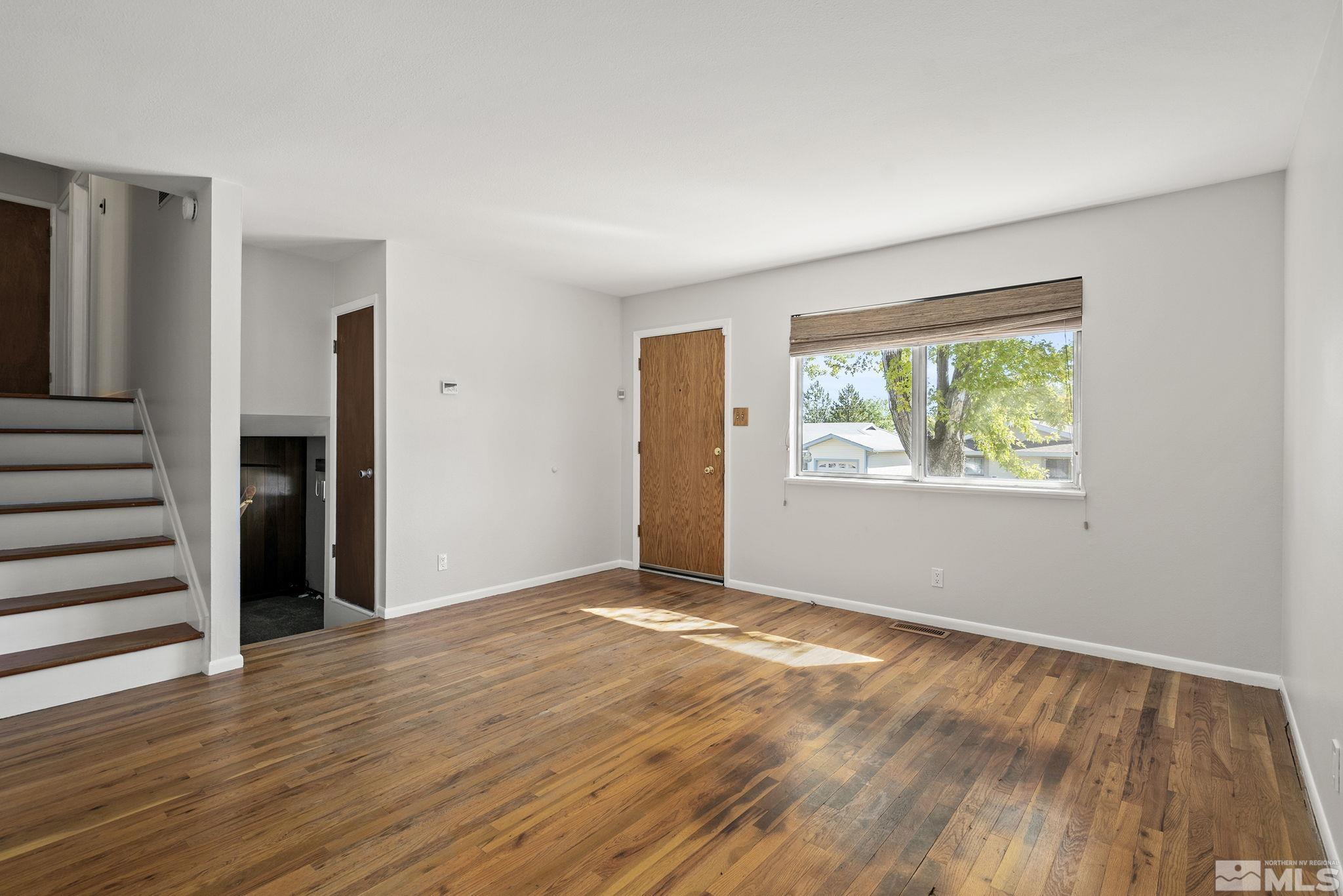 3495 Rauscher Drive Reno, NV 89503 - Photo 8 of 25 a view of an empty room with wooden floor and a window