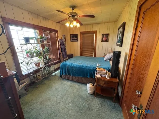 a bedroom with furniture and a window