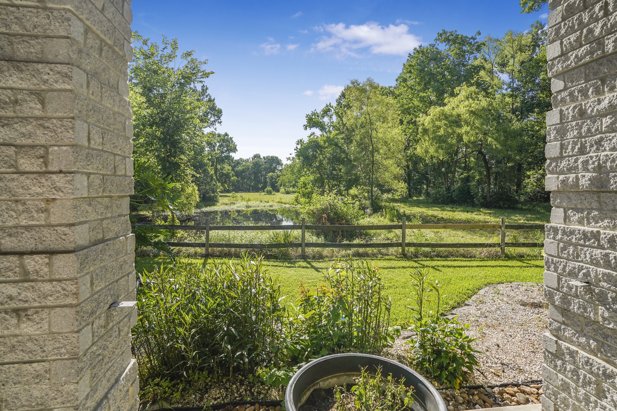 20547 Crosby Eastgate Road Crosby, TX 77532 - Photo 9 of 44 A view of the pond in front of the main house.