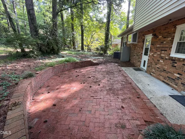 a view of a backyard with large trees