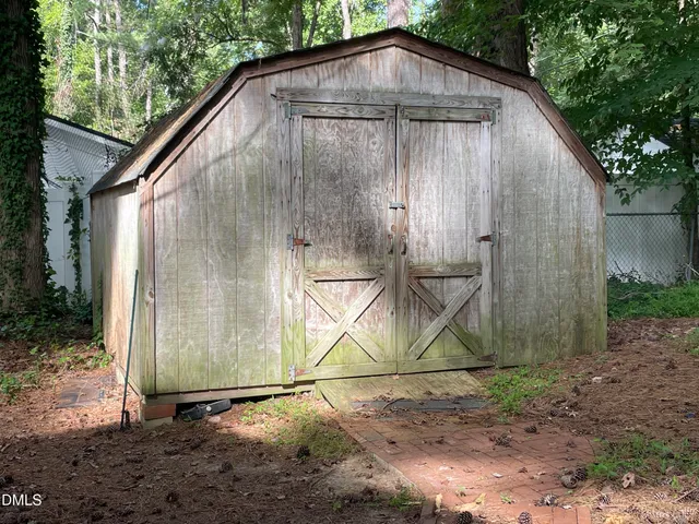 a backyard of a house with barbeque oven