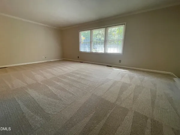 an empty room with a empty space and windows