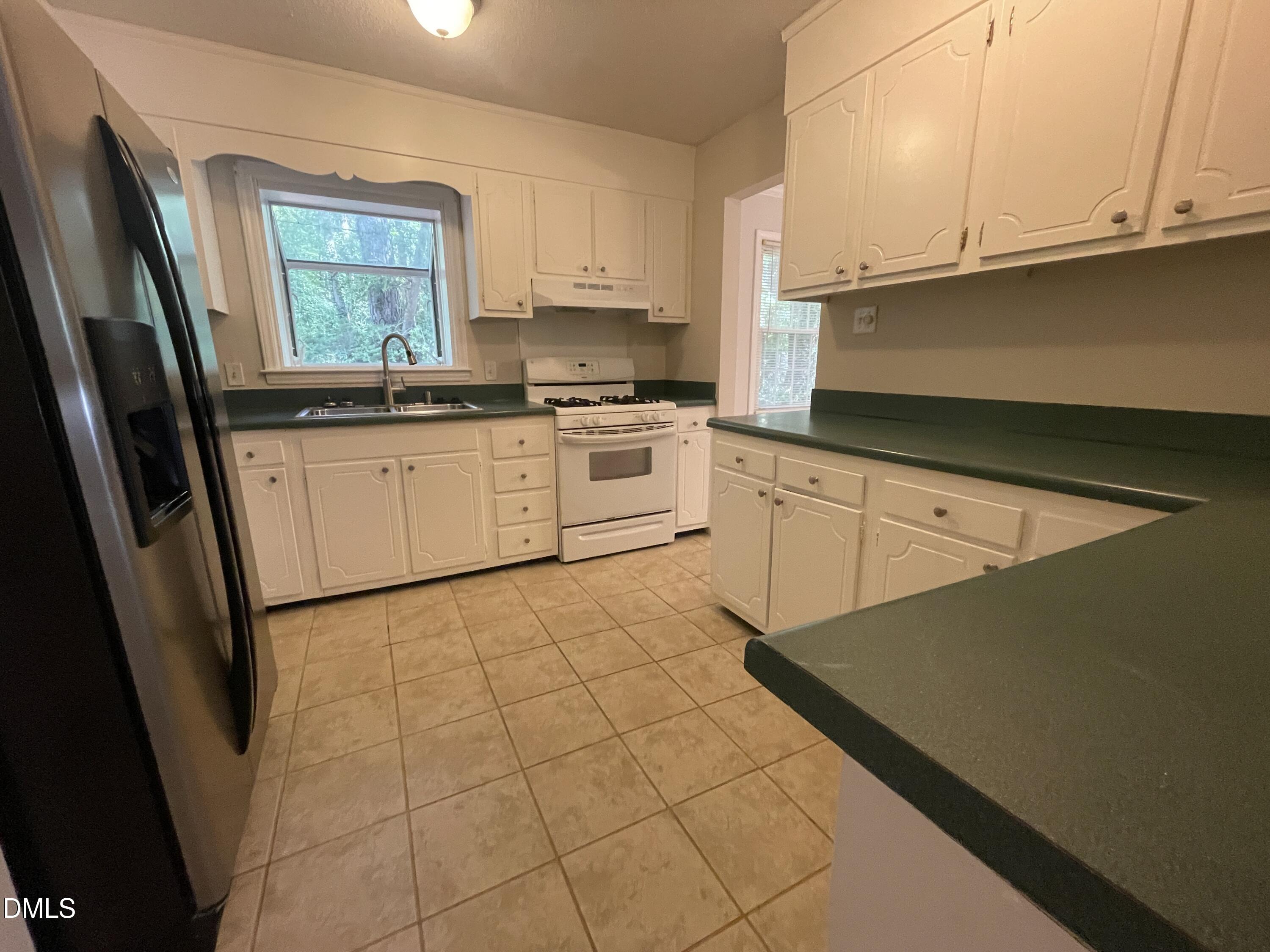 314 Brandywine Road Chapel Hill, NC 27516 - Photo 3 of 17 a kitchen with a stove window and cabinets
