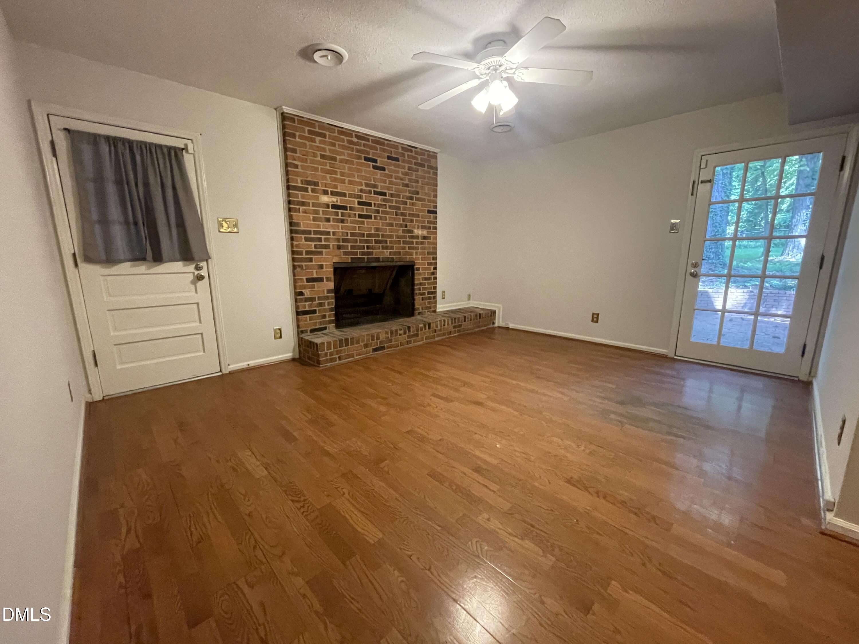 314 Brandywine Road Chapel Hill, NC 27516 - Photo 5 of 17 an empty room with windows and fireplace