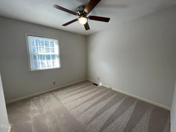 a view of an empty room and a window
