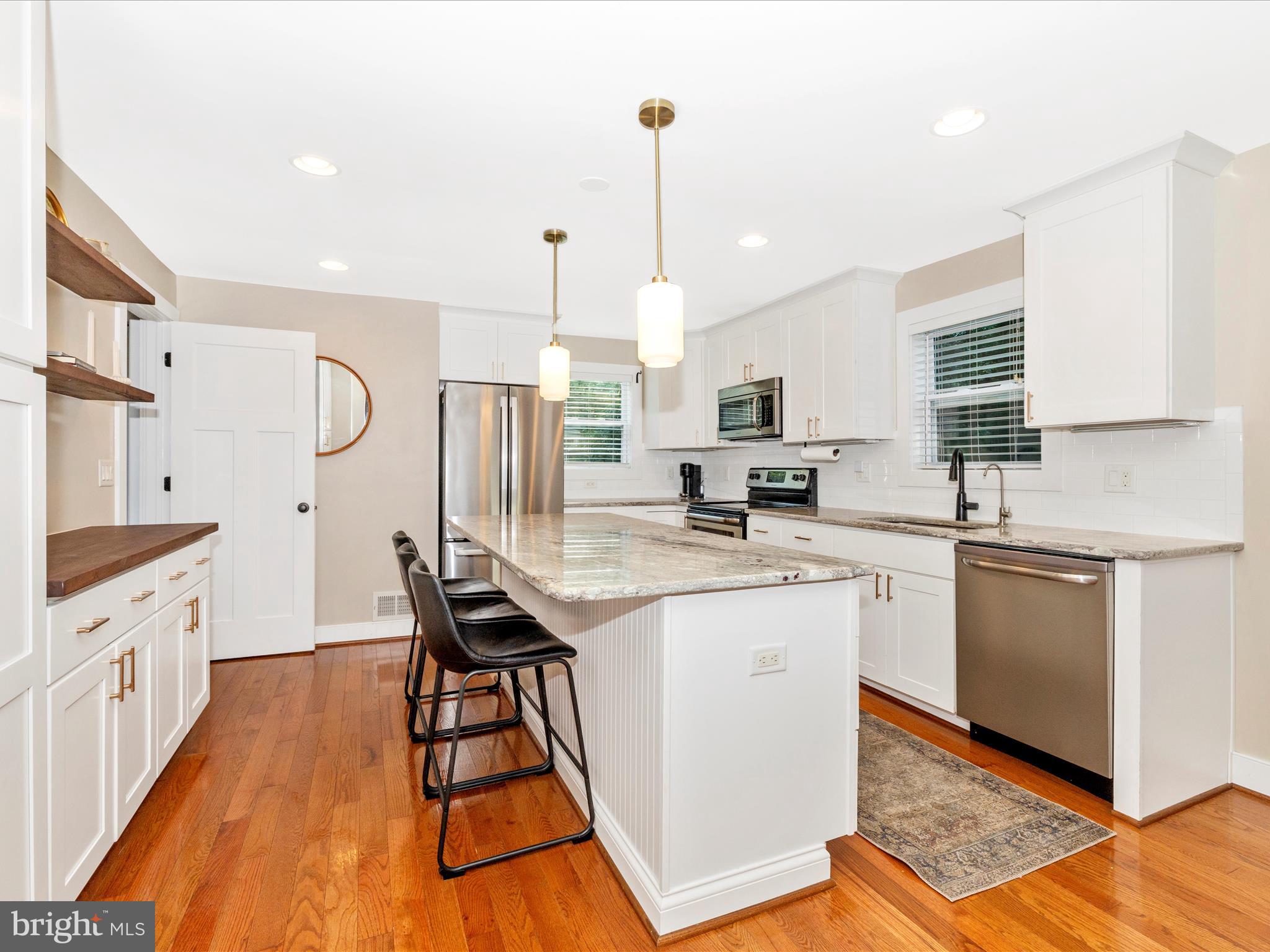 4533 Mountville Road Frederick, MD 21703 - Photo 16 of 70 a kitchen with granite countertop white cabinets sink and stainless steel appliances