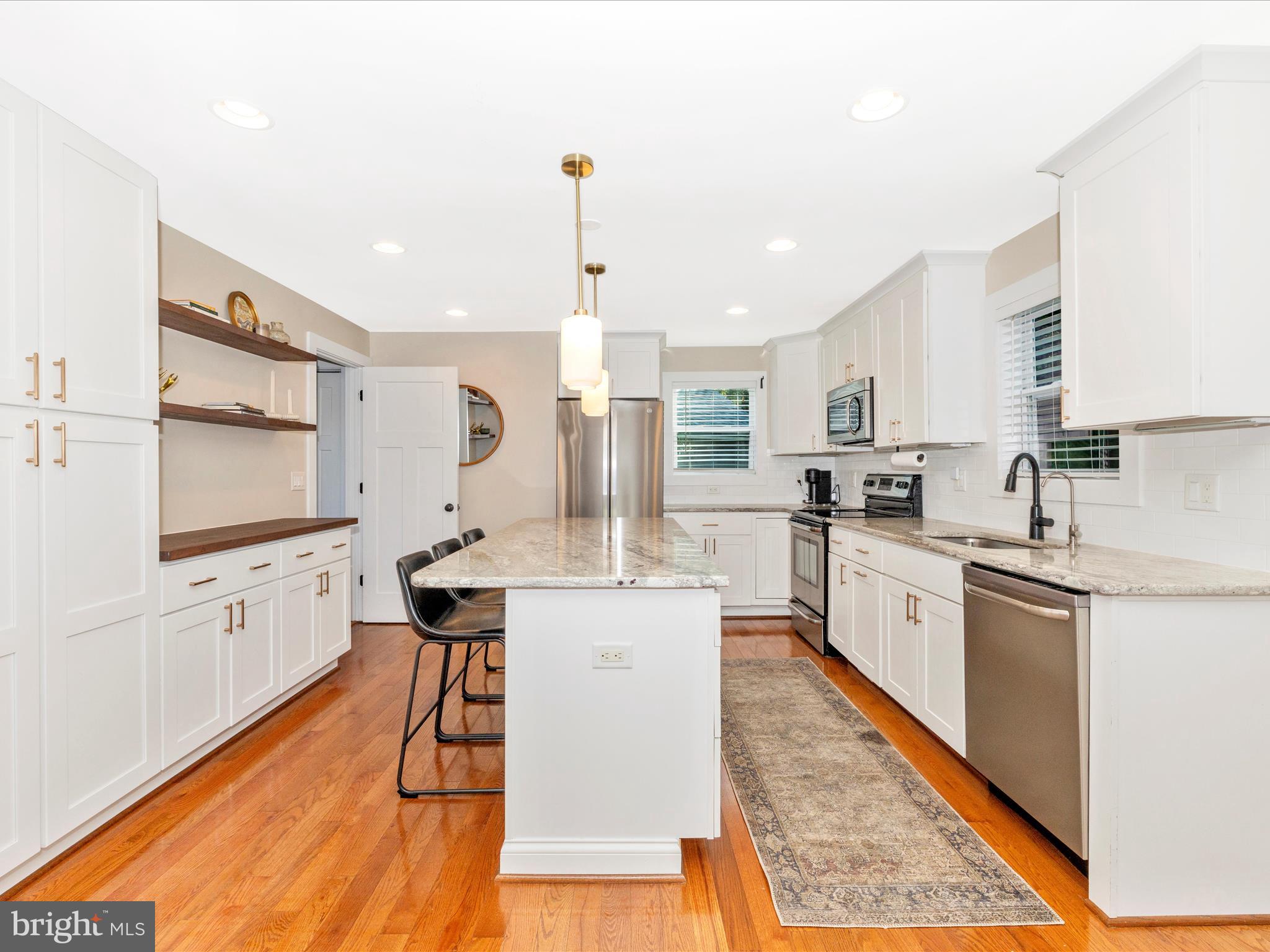 4533 Mountville Road Frederick, MD 21703 - Photo 17 of 70 a kitchen with stainless steel appliances kitchen island granite countertop wooden floors granite counter tops and a window