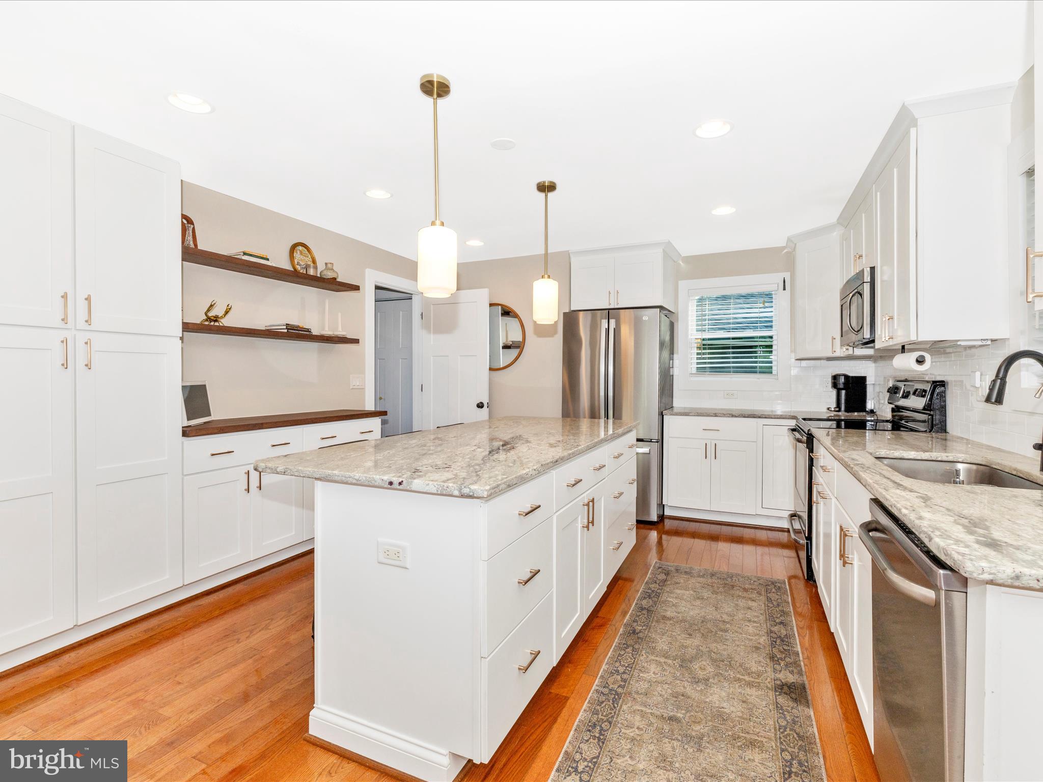 4533 Mountville Road Frederick, MD 21703 - Photo 18 of 70 a kitchen with stainless steel appliances granite countertop a stove a sink and a refrigerator