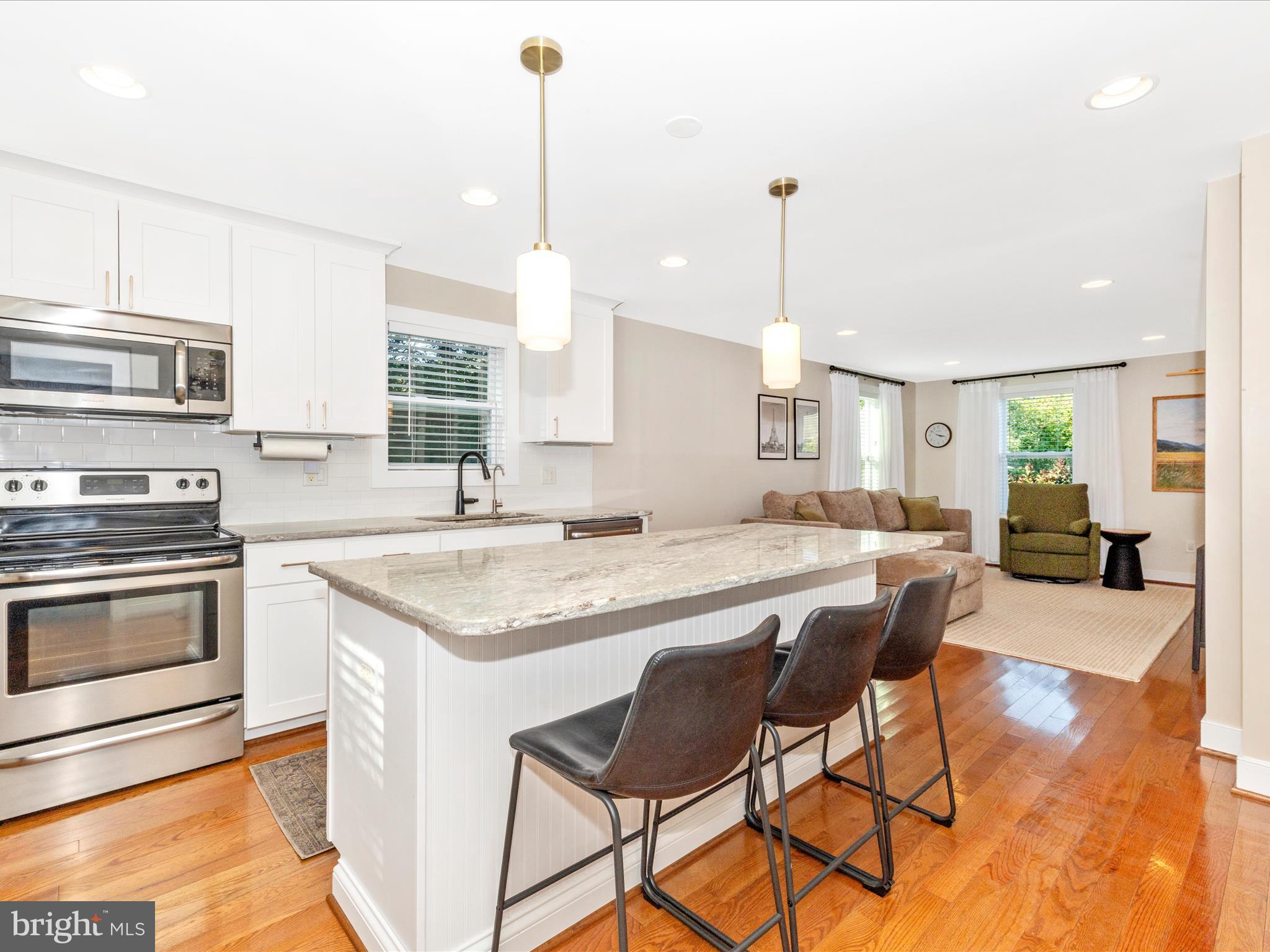 4533 Mountville Road Frederick, MD 21703 - Photo 20 of 70 a kitchen with stainless steel appliances granite countertop a stove a sink island and a refrigerator with wooden floor