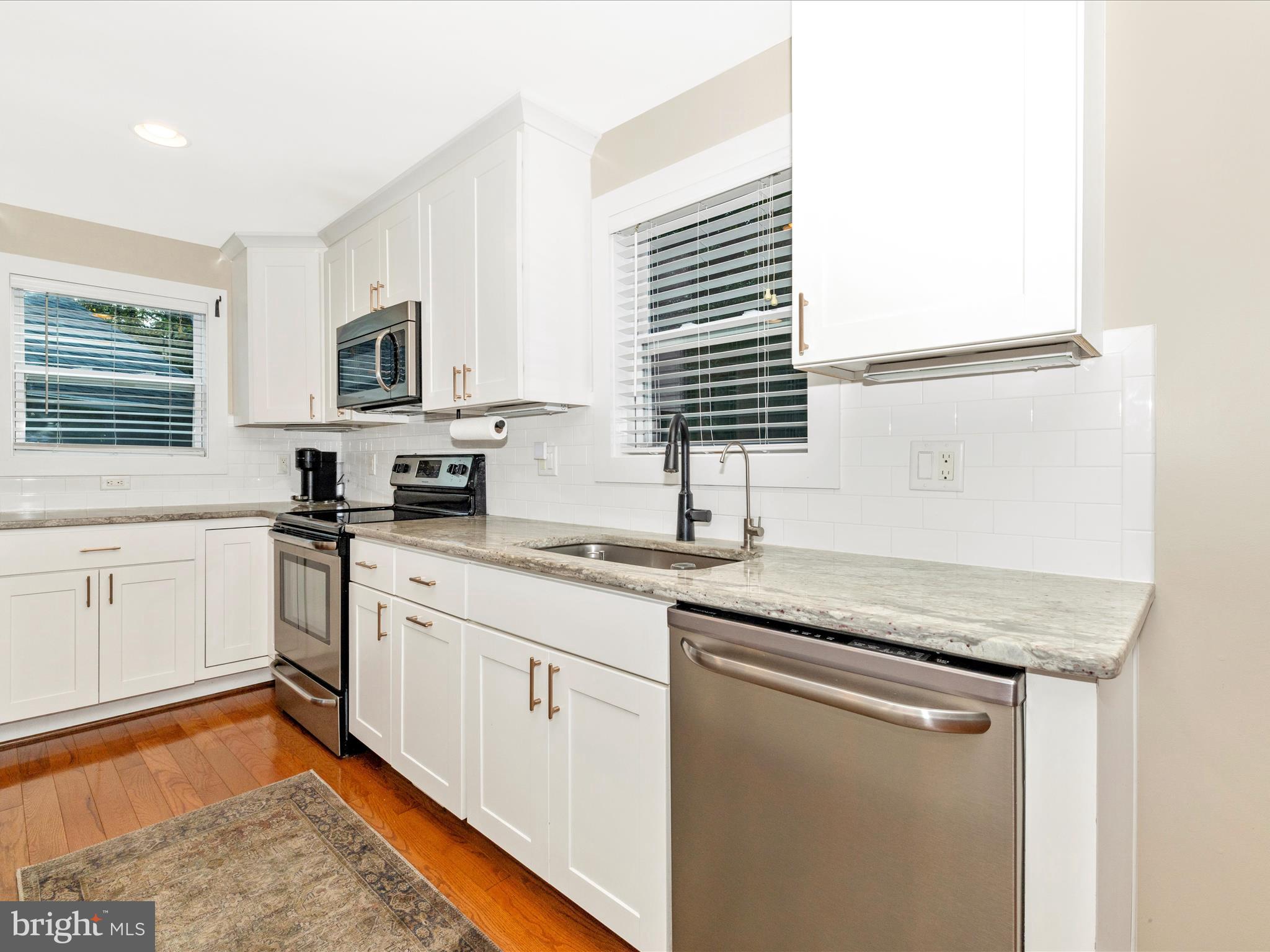 4533 Mountville Road Frederick, MD 21703 - Photo 21 of 70 a kitchen with stainless steel appliances granite countertop a sink stove and microwave