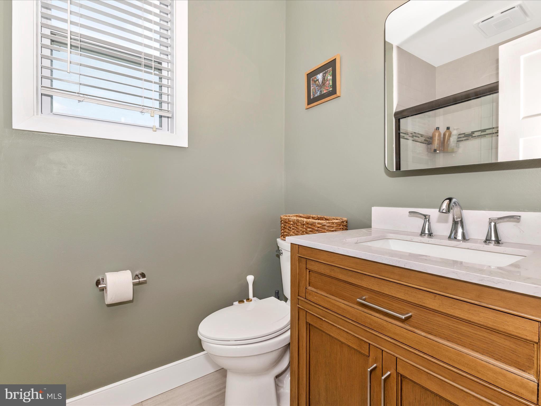 4533 Mountville Road Frederick, MD 21703 - Photo 30 of 70 a bathroom with a granite countertop toilet sink and mirror