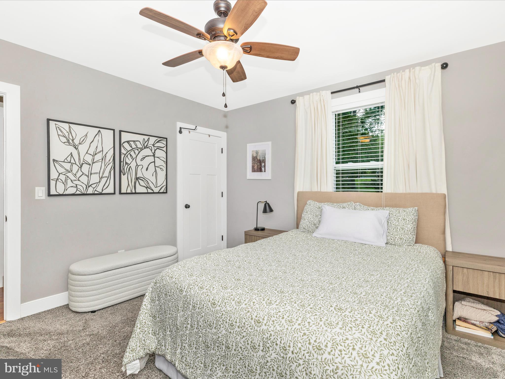4533 Mountville Road Frederick, MD 21703 - Photo 34 of 70 a bedroom with a large bed and a chandelier