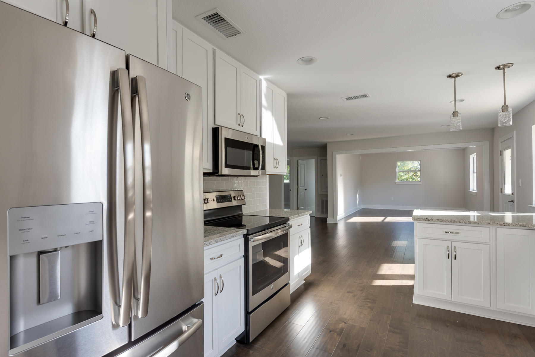 80 My Way Santa Rosa Beach, FL 32459 - Photo 11 of 33 a kitchen with granite countertop a refrigerator stove and sink