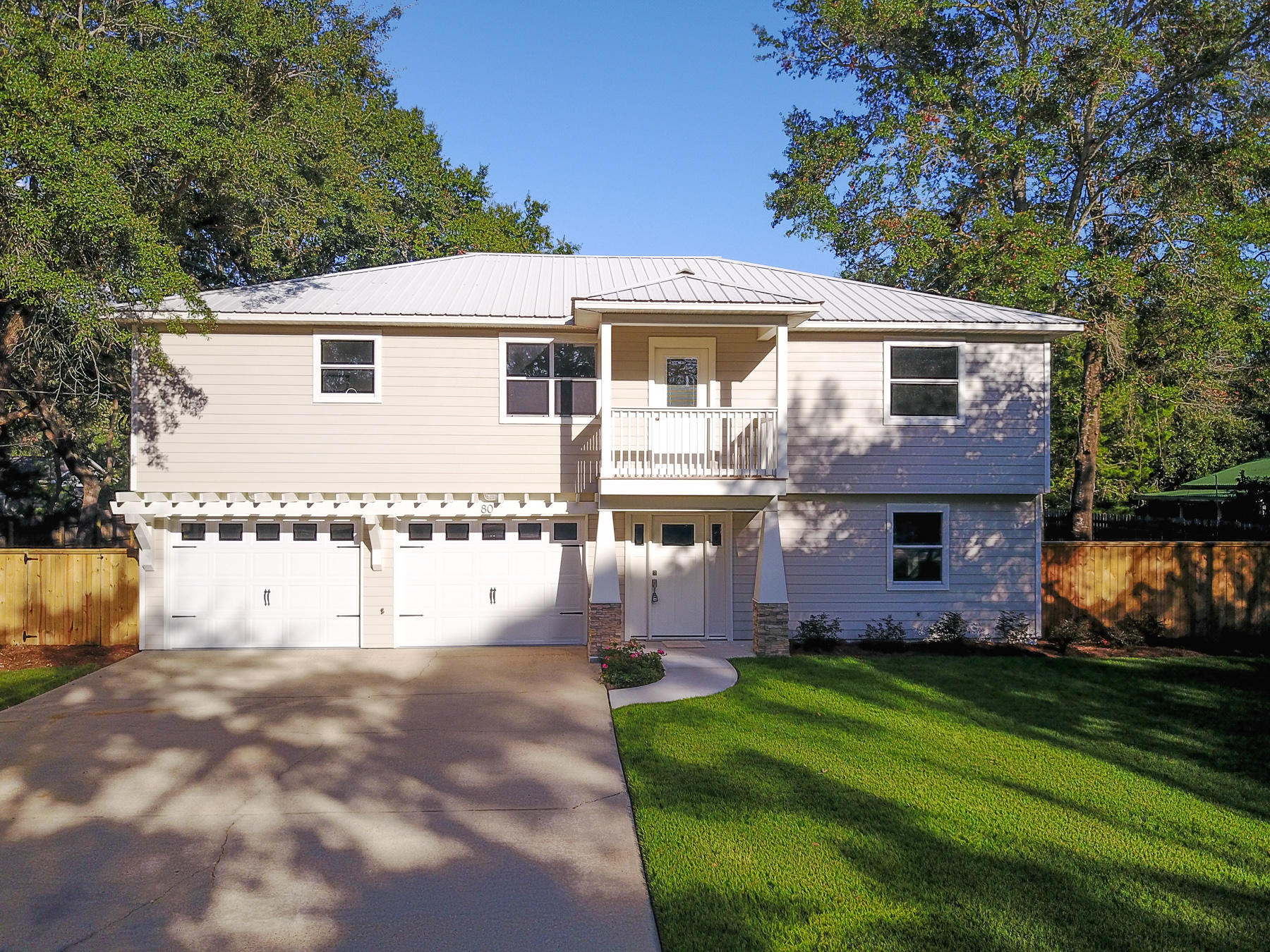 80 My Way Santa Rosa Beach, FL 32459 - Photo 3 of 33 a front view of a house with a garden and yard