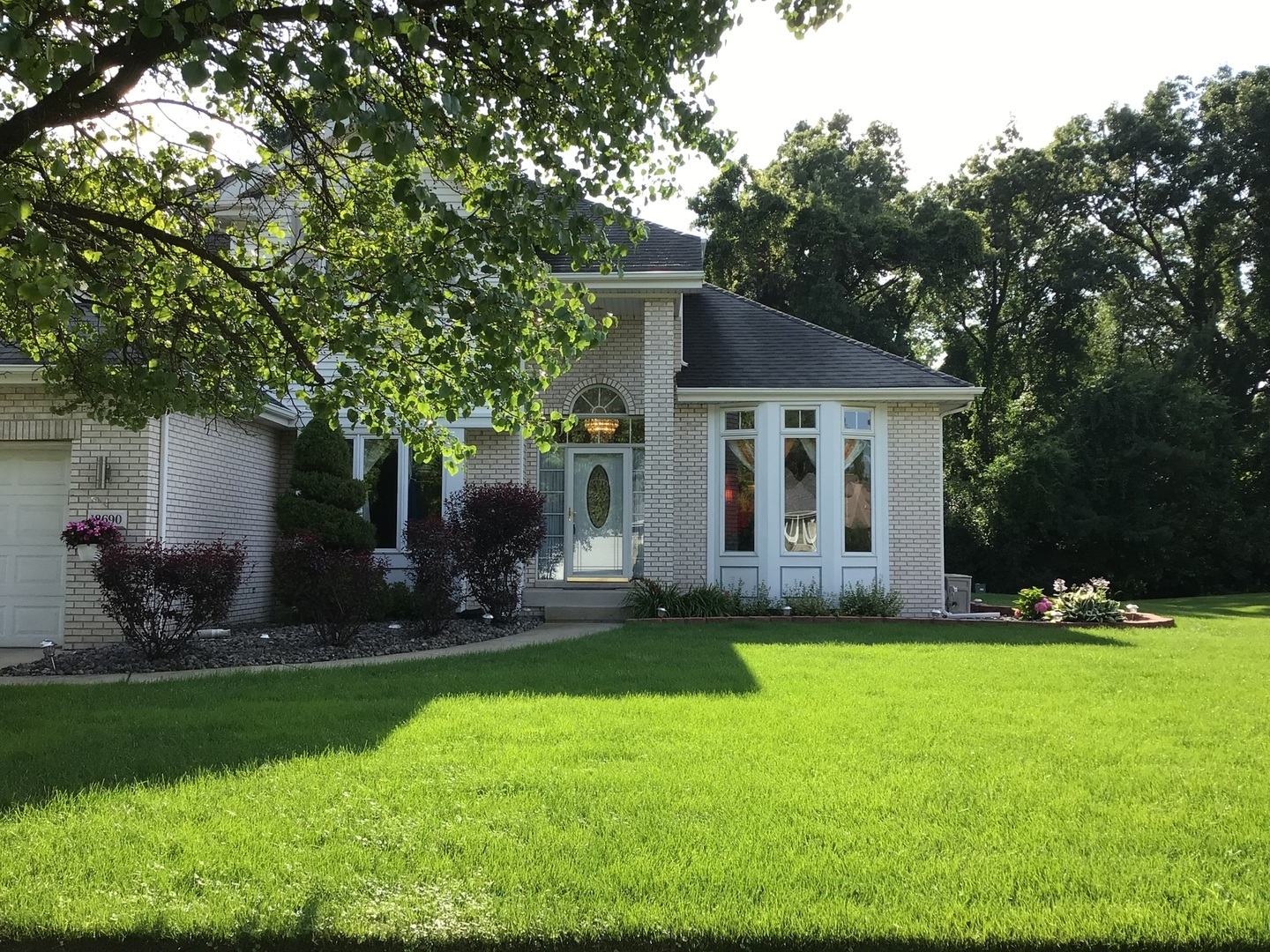 a view of a house with a yard and sitting area