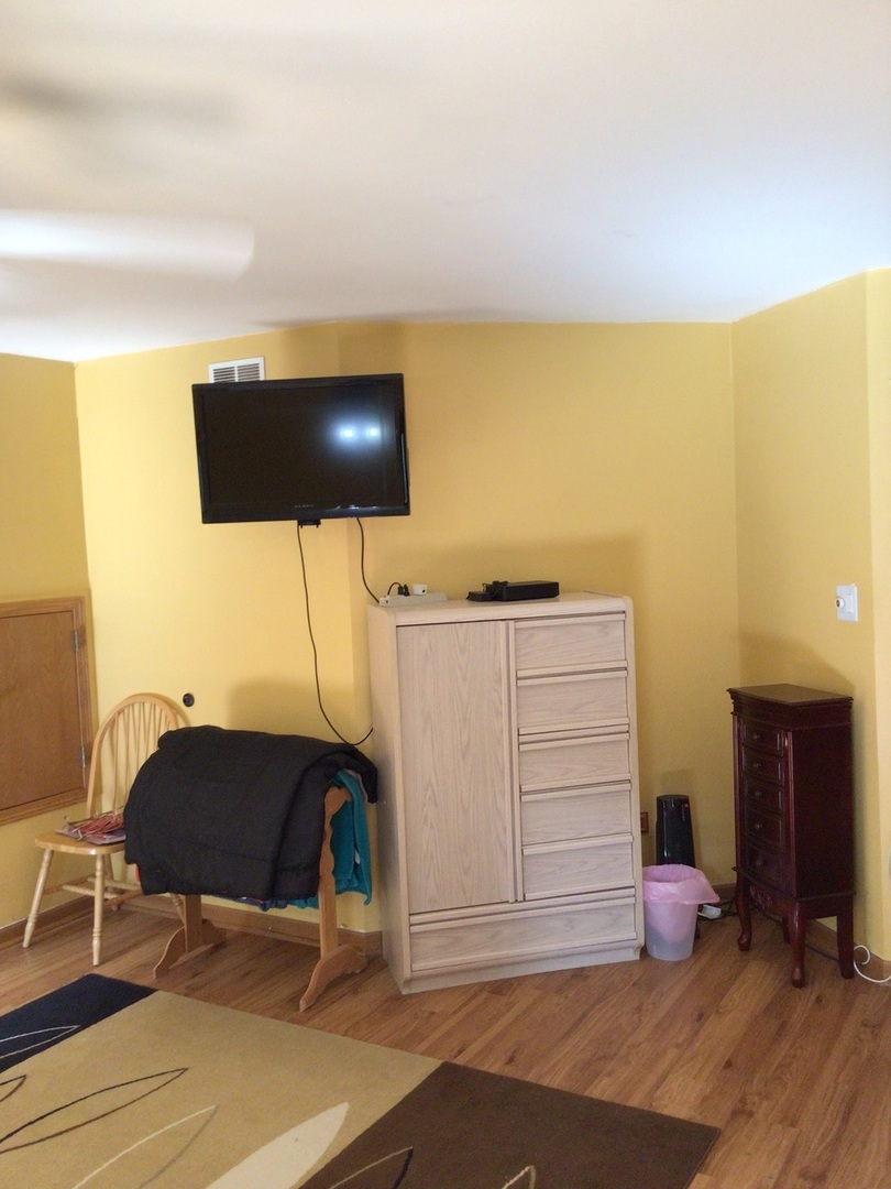 18690 Forest View Lane Lansing, IL 60438 - Photo 14 of 32 a bedroom with a bed and cabinets