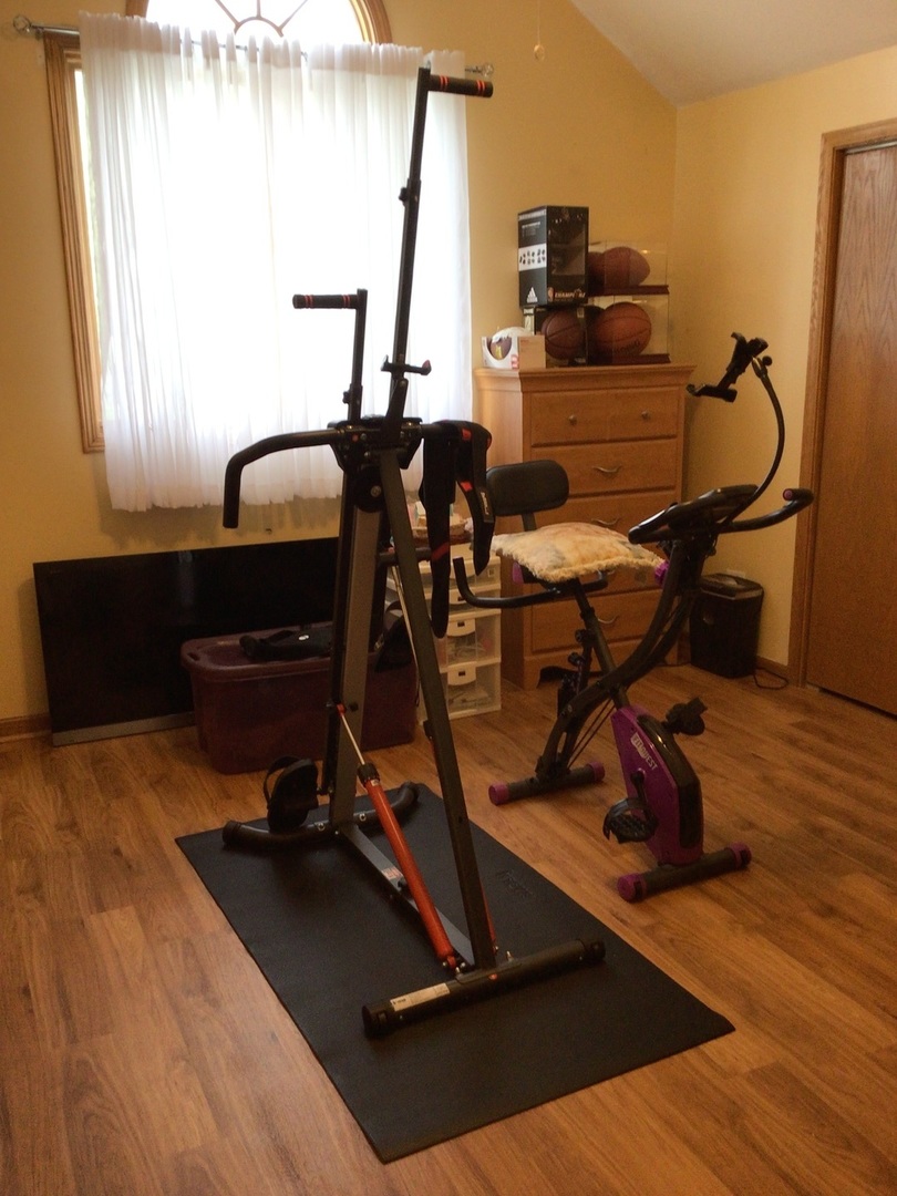 18690 Forest View Lane Lansing, IL 60438 - Photo 15 of 32 a room with gym equipment and wooden floor
