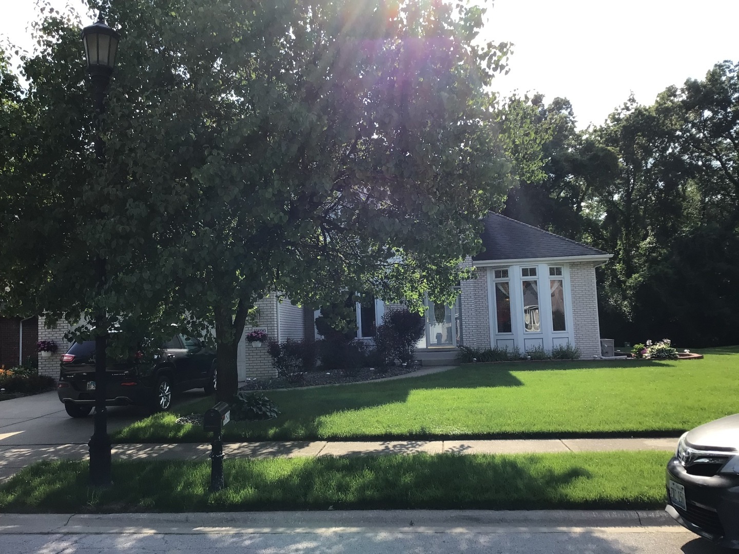 18690 Forest View Lane Lansing, IL 60438 - Photo 2 of 32 a front view of a house with a garden and trees