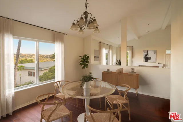 a dining room with furniture a chandelier and wooden floor