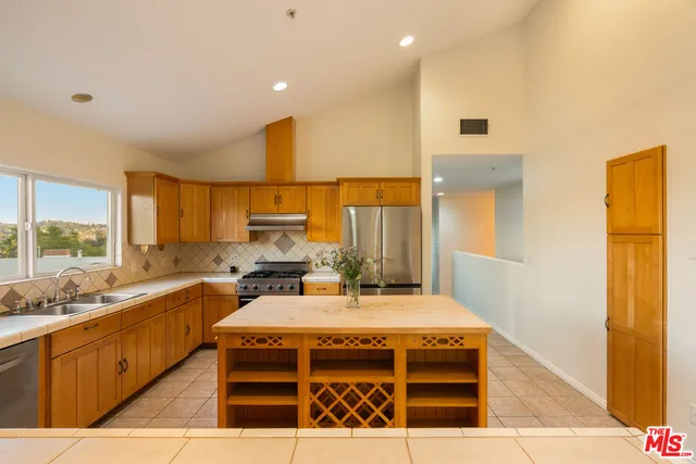 a kitchen with a stove a sink and a refrigerator