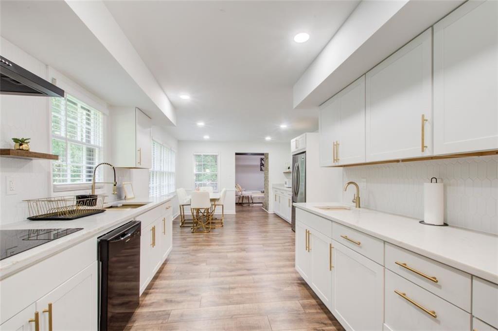 2085 High Point Trail Southwest Atlanta, GA 30331 - Photo 15 of 36 a large kitchen with stainless steel appliances granite countertop a lot of counter space and a sink