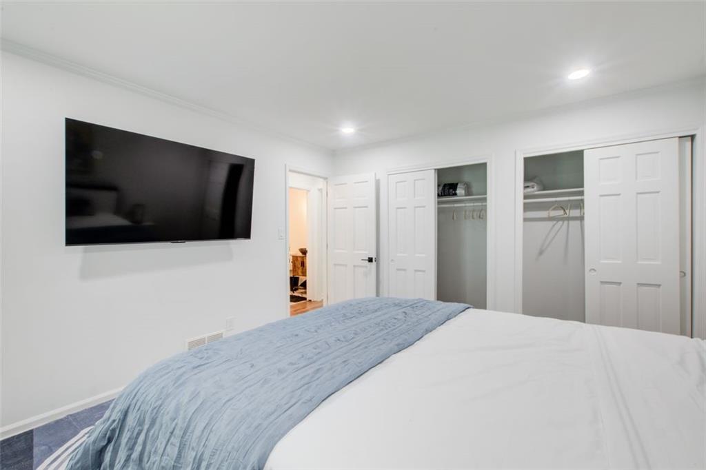 2085 High Point Trail Southwest Atlanta, GA 30331 - Photo 24 of 36 a bedroom with a bed and a flat screen tv