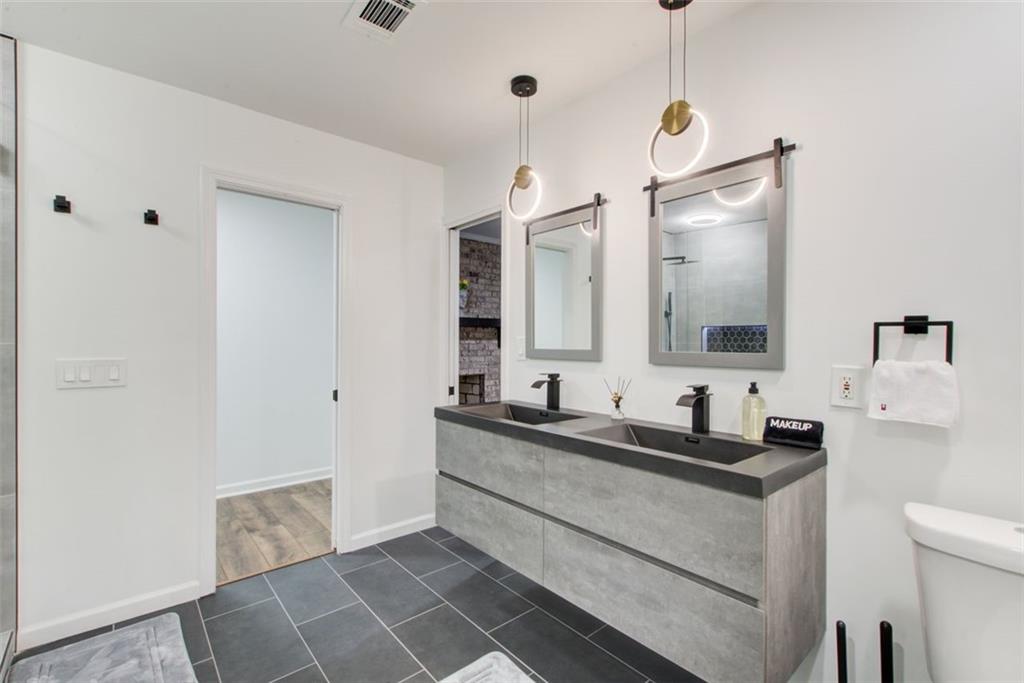 2085 High Point Trail Southwest Atlanta, GA 30331 - Photo 29 of 36 a bathroom with a double vanity sink and mirror