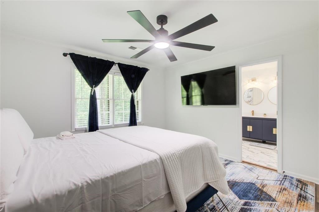 2085 High Point Trail Southwest Atlanta, GA 30331 - Photo 32 of 36 a bedroom with a bed and a flat screen tv